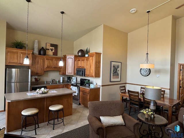kitchen with a kitchen island, pendant lighting, brown cabinets, high vaulted ceiling, and stainless steel appliances