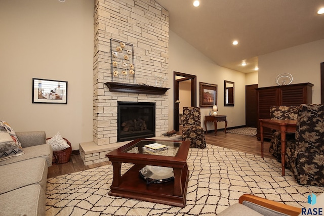 living area featuring baseboards, recessed lighting, wood finished floors, and a fireplace