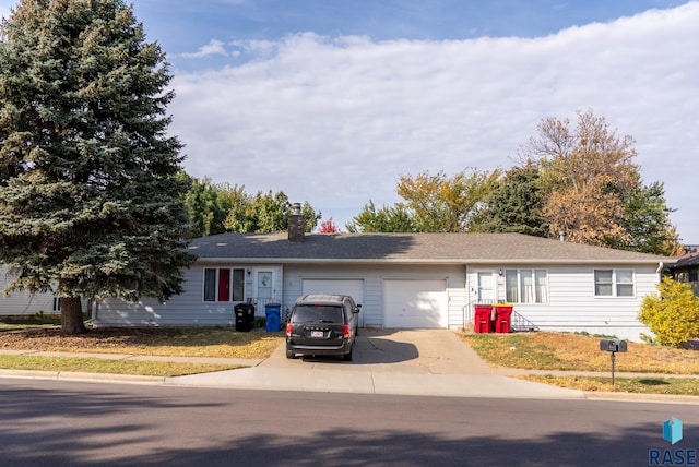 4805 S Baha Ave, Sioux Falls, SD 57106 - ranch-style home with an attached garage, a chimney, and driveway