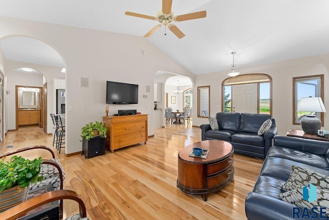 47604 255th St, Garretson, SD 57030 - living room featuring arched walkways, light wood-type flooring, lofted ceiling, and ceiling fan with notable chandelier