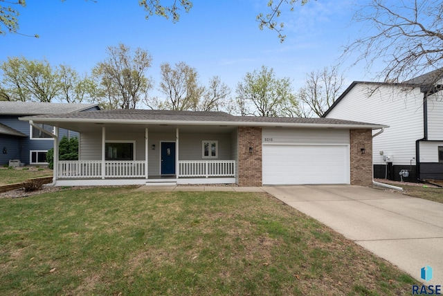 5215 E Belmont St, Sioux Falls, SD 57110 - view of front of home with an attached garage, a porch, driveway, and brick siding