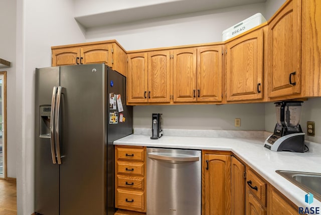 5215 E Belmont St, Sioux Falls, SD 57110 - kitchen with light countertops, stainless steel appliances, and brown cabinetry