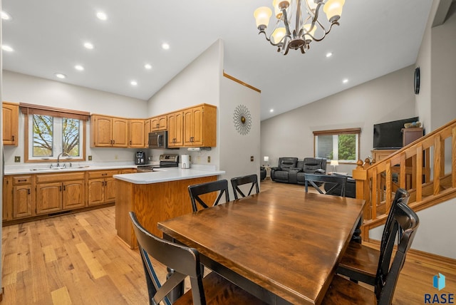 5215 E Belmont St, Sioux Falls, SD 57110 - dining space featuring recessed lighting, high vaulted ceiling, an inviting chandelier, and light wood-style flooring