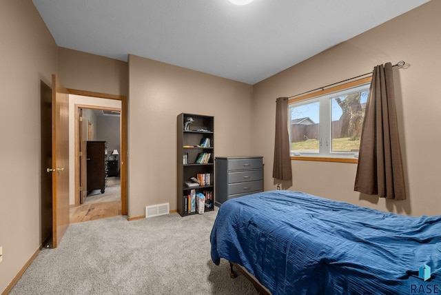 5215 E Belmont St, Sioux Falls, SD 57110 - bedroom with baseboards, visible vents, and light carpet