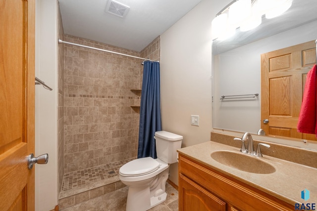 5215 E Belmont St, Sioux Falls, SD 57110 - full bath with vanity, toilet, tile patterned floors, visible vents, and tiled shower