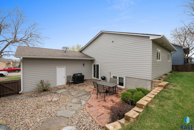 5215 E Belmont St, Sioux Falls, SD 57110 - rear view of property with fence, a lawn, a patio area, and roof with shingles