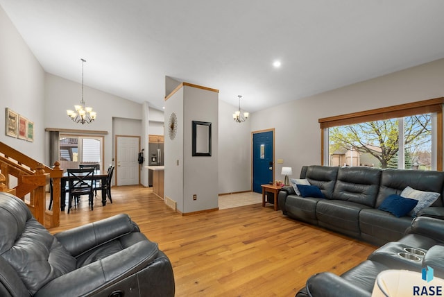 5215 E Belmont St, Sioux Falls, SD 57110 - living room with a wealth of natural light, lofted ceiling, light wood-style flooring, and a notable chandelier
