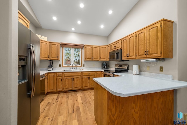 5215 E Belmont St, Sioux Falls, SD 57110 - kitchen with appliances with stainless steel finishes, brown cabinets, a sink, light countertops, and a peninsula