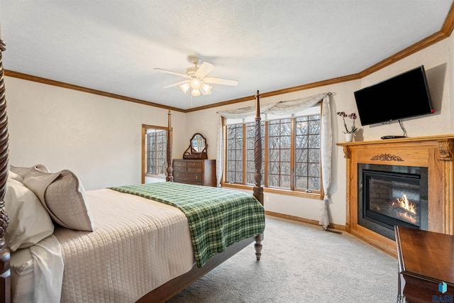 1705 N Deer Hollow Cir, Sioux Falls, SD 57110 - bedroom with a ceiling fan, carpet floors, baseboards, a glass covered fireplace, and ornamental molding