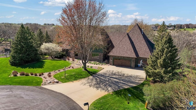 1705 N Deer Hollow Cir, Sioux Falls, SD 57110 - view of front of home with stone siding, driveway, a front yard, and a garage