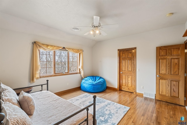 1705 N Deer Hollow Cir, Sioux Falls, SD 57110 - bedroom featuring a ceiling fan, baseboards, vaulted ceiling, light wood-type flooring, and visible vents