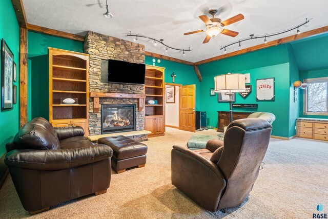 1705 N Deer Hollow Cir, Sioux Falls, SD 57110 - carpeted living area featuring track lighting, baseboards, ceiling fan, and a stone fireplace