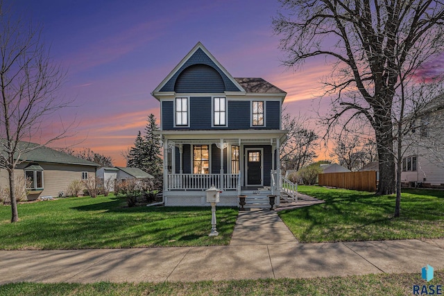 view of front of property with covered porch and a front yard