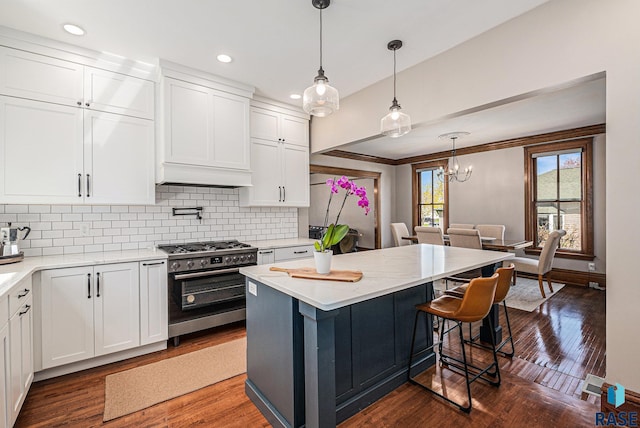 kitchen featuring white cabinetry, dark wood-style floors, decorative backsplash, and gas range