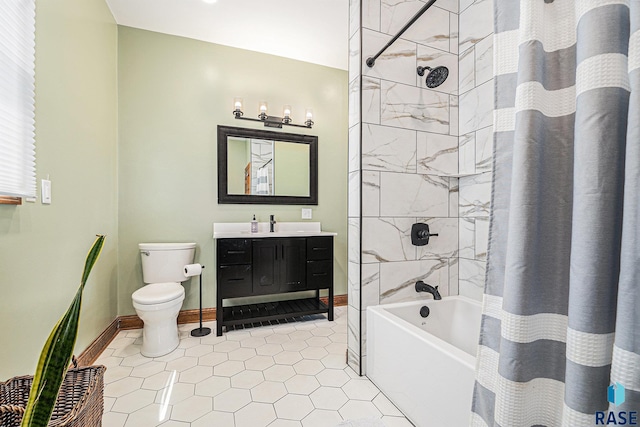 bathroom with vanity, toilet, baseboards, tile patterned floors, and shower / tub combo