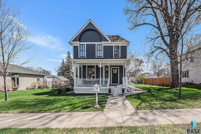 view of front of home with covered porch and a front lawn