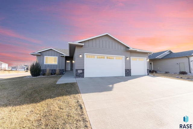 5400 S Whisper Cove Trl, Sioux Falls, SD 57108 - single story home with stone siding, a front yard, board and batten siding, an attached garage, and driveway