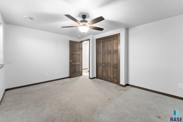5400 S Whisper Cove Trl, Sioux Falls, SD 57108 - unfurnished bedroom with baseboards, ceiling fan, carpet, and a closet