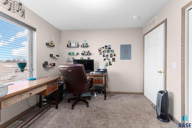 office featuring carpet flooring, baseboards, visible vents, and electric panel