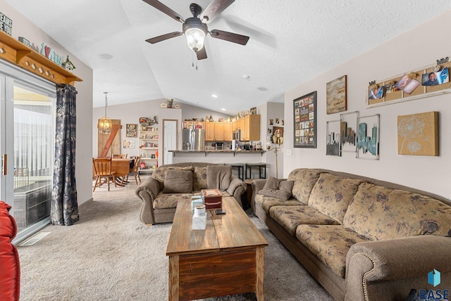 carpeted living area featuring ceiling fan and vaulted ceiling