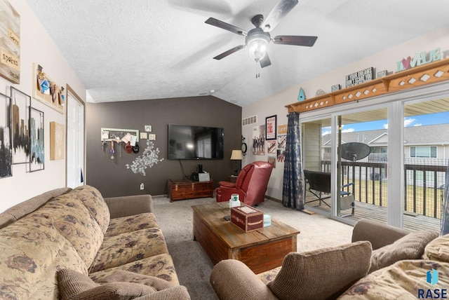 carpeted living area featuring ceiling fan, visible vents, baseboards, and lofted ceiling