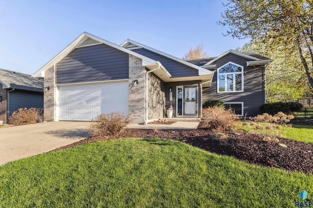 view of front of home featuring a garage, a front yard, driveway, and brick siding