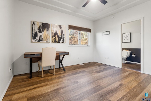 office space featuring baseboards, a ceiling fan, and wood finished floors