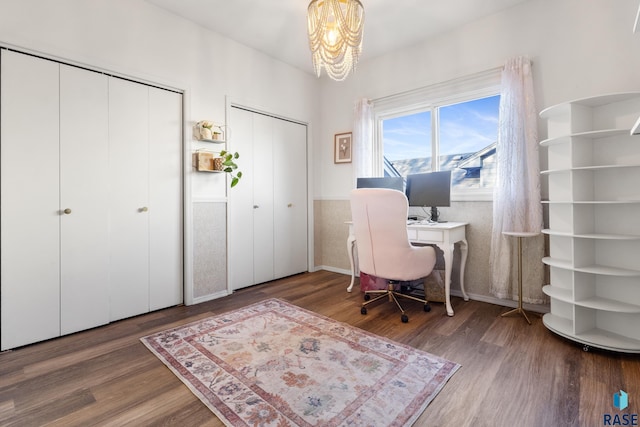 office area featuring wood finished floors and a notable chandelier