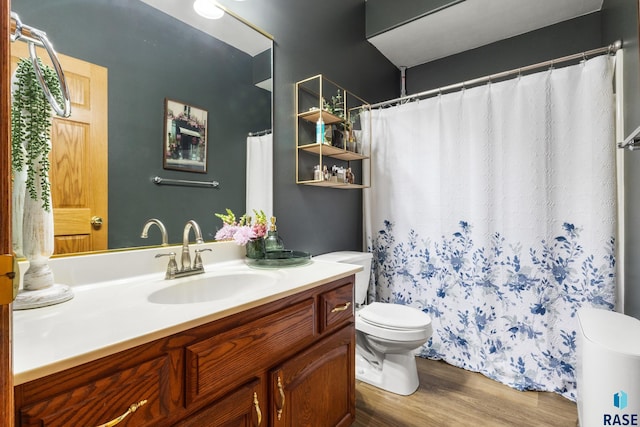 bathroom featuring vanity, toilet, and wood finished floors