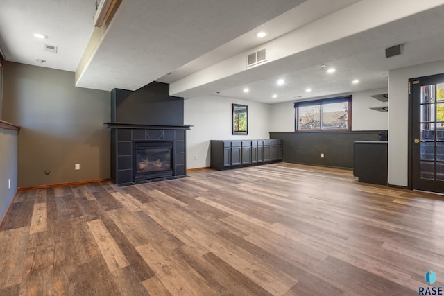 unfurnished living room with recessed lighting, baseboards, visible vents, and wood finished floors