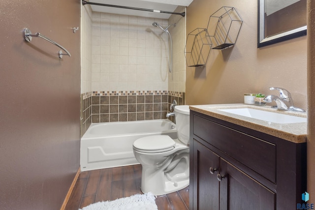 bathroom featuring vanity, toilet, wood finished floors, and shower / bathing tub combination