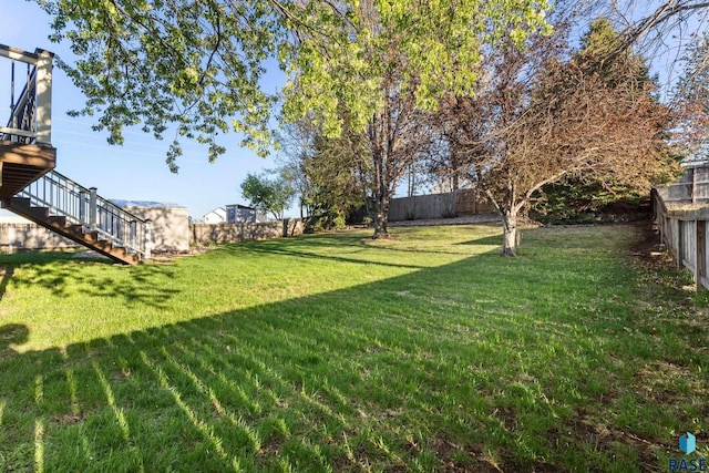 view of yard with stairway and a fenced backyard