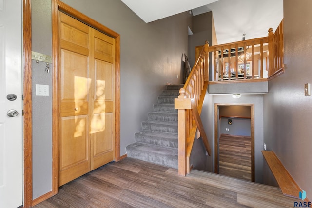 staircase with baseboards and wood finished floors