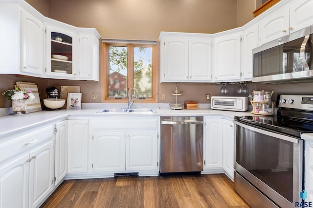 kitchen featuring light countertops, white cabinetry, appliances with stainless steel finishes, and a sink