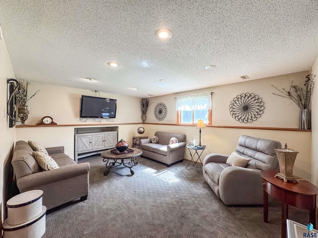 living area featuring carpet floors, recessed lighting, a textured ceiling, and visible vents