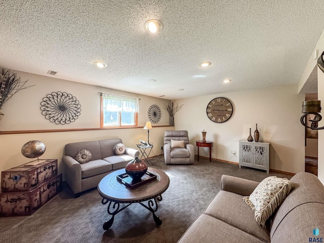 carpeted living area featuring recessed lighting, a textured ceiling, and visible vents