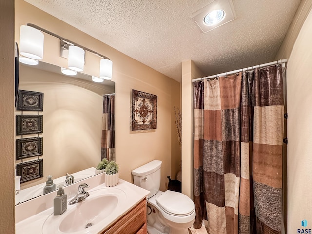 bathroom featuring toilet, a textured ceiling, a shower with curtain, and vanity