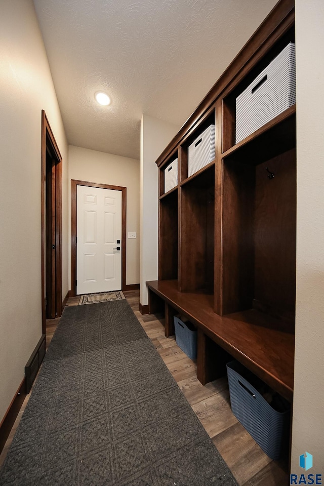 mudroom with recessed lighting, baseboards, and wood finished floors