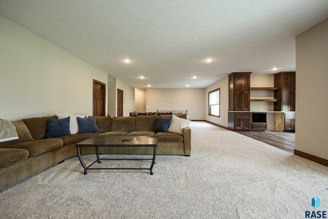 living room featuring carpet flooring, recessed lighting, and baseboards