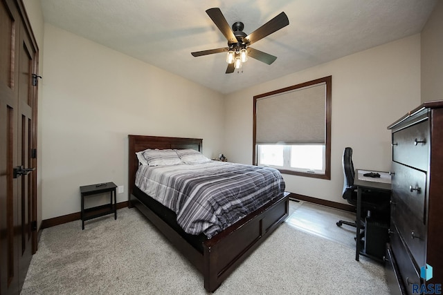 bedroom with baseboards, light carpet, and a ceiling fan