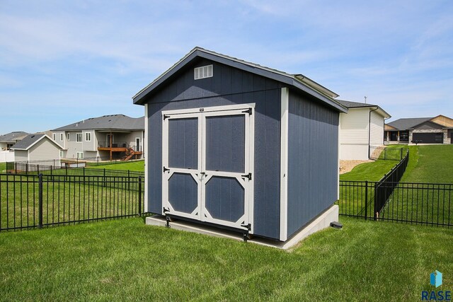 view of shed with a fenced backyard and a residential view