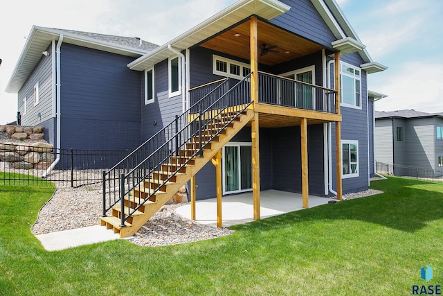 back of house with a ceiling fan, a lawn, fence, a patio, and stairs