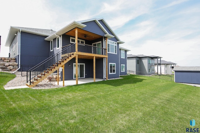 rear view of property with a yard, a patio, ceiling fan, and stairs