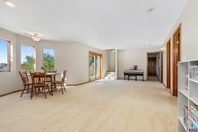 carpeted dining space featuring recessed lighting and baseboards
