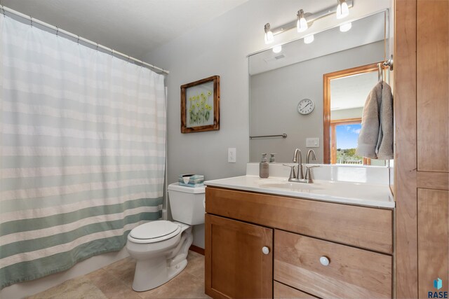 bathroom with visible vents, tile patterned flooring, curtained shower, vanity, and toilet