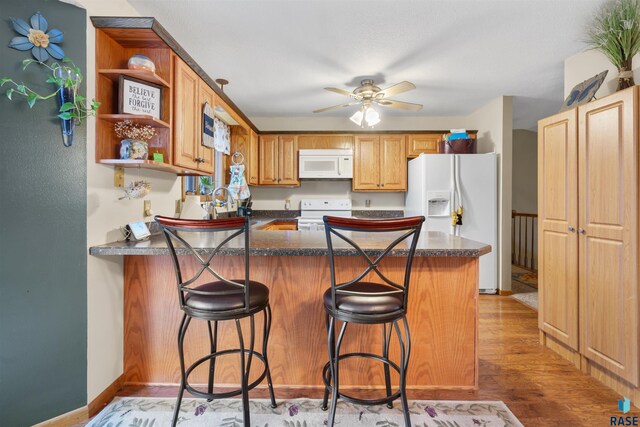 kitchen featuring open shelves, white appliances, a peninsula, a ceiling fan, and light wood-type flooring