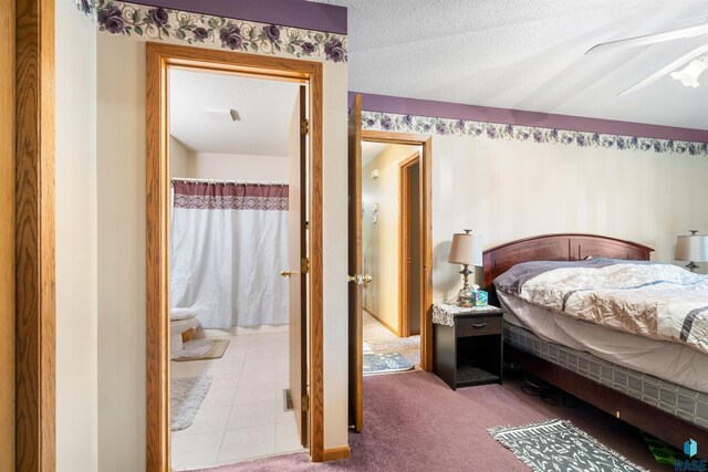 carpeted bedroom featuring ensuite bath