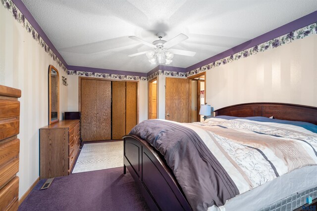 carpeted bedroom featuring a ceiling fan and wallpapered walls