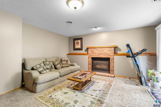 living room featuring carpet floors, a brick fireplace, a textured ceiling, baseboards, and visible vents