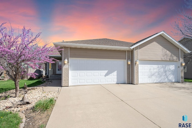 ranch-style home with an attached garage and driveway